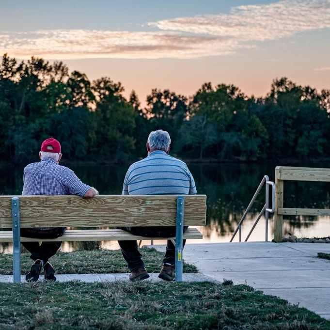 Men sitting by the lake
